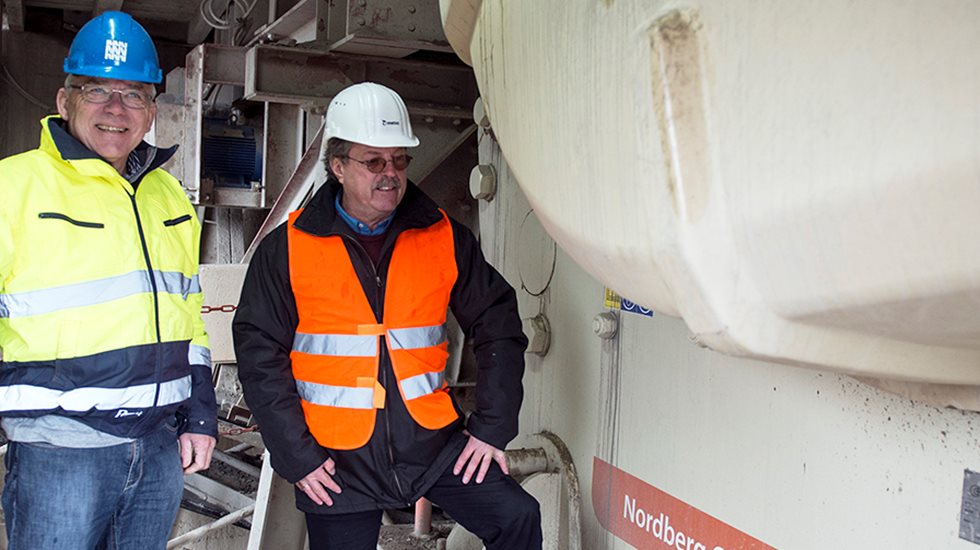 Two employees next to Nordberg C150 jaw crusher at Clemens quarry.