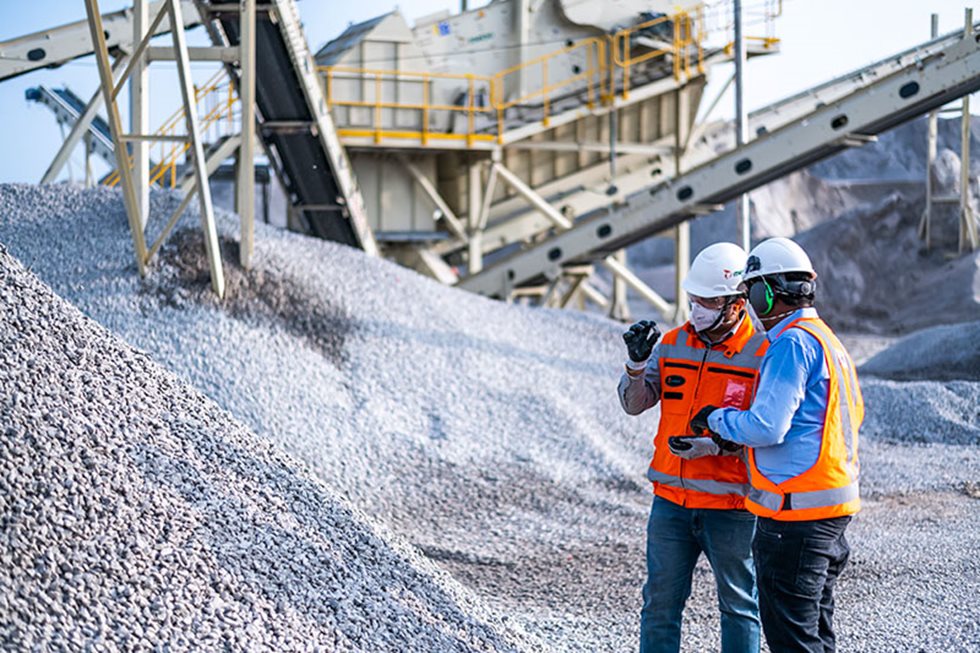 Two men at a quarry producing artificial sand.