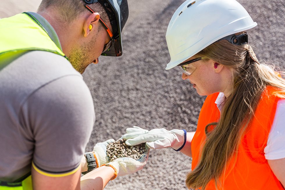 A man and a woman taking a closer look at aggregates. 