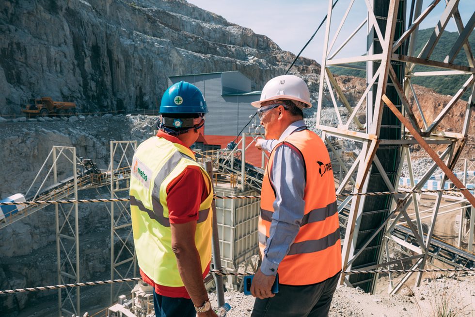 Two men looking down at the quarry.