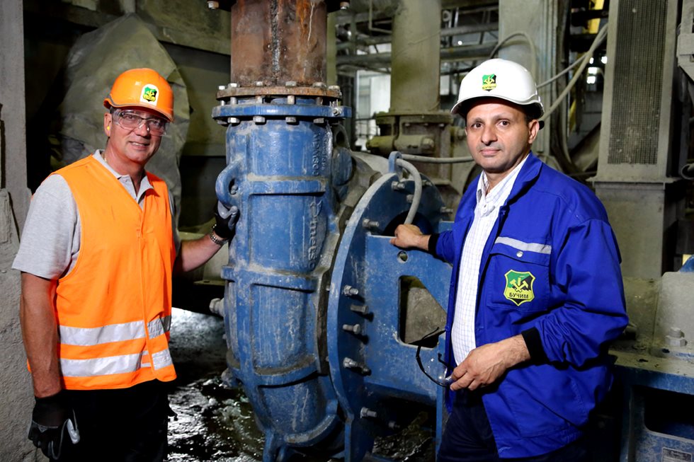 Two men standing next to MDM300 mill discharge pump.